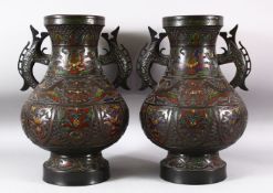 A PAIR OF JAPANESE CHAMPLEVE BRONZE CLOISONNE TWIN HANDLE VASES, the body decorated with enamelled