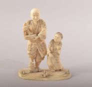 A JAPANESE CARVED IVORY FIGURE OF MAN WITH FISH and a boy at his side, 10cm high.