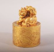 A CHINESE GILT BRONZE LION DOG SEAL - the top with two lion dogs - the underside with four character