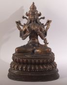 A TIBETAN GILT COPPER ALLOY FIGURE OFF BUDDHA / GREEN TARA - seated upon a lotus base - sat in