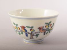 A CHINESE PORCELAIN DOUCAI CUP, painted with birds and peach blossom, six character mark to base,