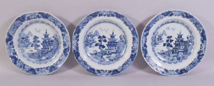 THREE CHINESE BLUE AND WHITE PORCELAIN PLATES, each painted with temples in a landscape, each
