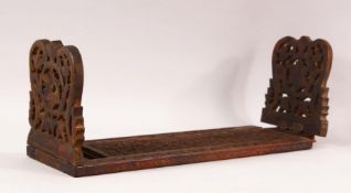 A 19TH CENTURY ISLAMIC CARVED WOOD BOOK STAND, with folding end sections carved and pierced with