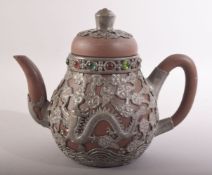 A CHINESE YIXING TEAPOT, with metal mounts and inlaid rim, impressed mark to metal base, 15cm high.