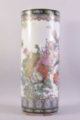 A CHINESE FAMILLE ROSE PORCELAIN WALKING STICK STAND, vividly decorated with peacocks amongst native