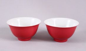 A PAIR OF 19TH / 20TH CENTURY CHINESE RUBY RED GLAZED PORCELAIN TEA BOWLS, with a ruby red / pink