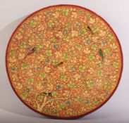 AN INDIAN KASHMIRI PAPER MACHE DISH, decorated with birds and scrolling vine, 27cm diameter. 530.