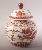 A CHINESE IRON RED DECORATED PORCELAIN JAR & COVER - the iron red decorated to depict phoenix