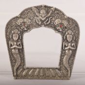 AN INDIAN OR NEPALESE WHITE METAL FRAME, 11.5cm x 11cm.