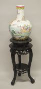 A LARGE LATE 19TH / EARLY 20TH CENTURY CHINESE FAMILLE ROSE PORCELAIN IMMORTAL VASE & STAND - the