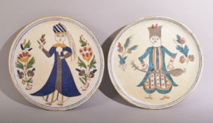 A PAIR OF TURKISH KUTAHYA PLATES, painted with a male and female figure and floral sprays, both 16cm
