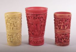 THREE CHINESE CANTON CARVED IVORY CUPS / DICE SHAKERS, largest 7cm high.