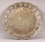 A SRI LANKAN POSSIBLY SILVER DISH, with embossed and chased decoration, 35cm diameter.