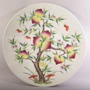 A SUPERB LARGE CHINESE PORCELAIN PEACH DISH, the centre painted with peach blossom and bats, red