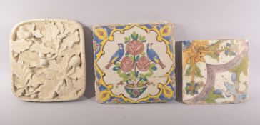 TWO PERSIAN GLAZED POTTERY TILES, together with another tile with relief decoration, signed to