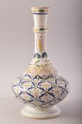 A TURKISH OTTOMAN KUTAHYA GLAZED POTTERY VASE, decorated with floral motifs, 29cm high.