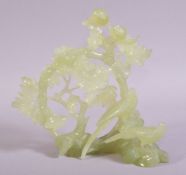 A CHINESE JADE CARVING OF PHEASANTS and blossoms, 16cm high, 17cm wide.