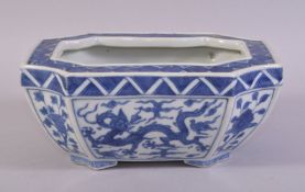 A CHINESE BLUE AND WHITE PORCELAIN RECTANGULAR PLANT POT, painted with dragons and flowers, six