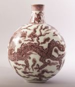 A CHINESE RED AND WHITE PORCELAIN DRAGON MOONFLASK / VASE, the body painted with a dragon on each
