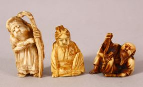 THREE JAPANESE MEIJI PERIOD CARVED IVORY NETSUKE - one depicting a lucky god holding his staff,