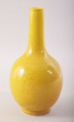 A SMALL CHINESE YELLOW GLAZE PORCELAIN BOTTLE VASE, incised under glaze with dragons and the flaming