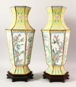 A LARGE PAIR OF CHINESE ENAMEL VASES & STANDS, the vases decorated upon a yellow ground with