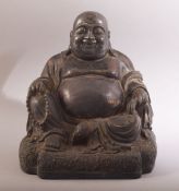 A CHINESE BRONZE SEATED BUDDHA, with faint traces of red and gilt, 26.5cm high.