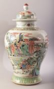 A CHINESE FAMILLE VERTE PORCELAIN VASE AND COVER, painted with scenes of warriors and other