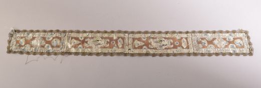 A CHINESE EMBROIDERED SILK TEXTILE, embroidered with various panels of figures, 96cm long.