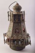A PERSIAN QAJAR BRASS OPENWORK HANGING LANTERN, with stained glass star windows and bird shaped