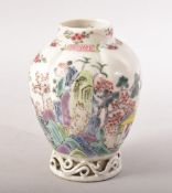 A SMALL CHINESE FAMILLE ROSE CADDY / VASE, painted with flowers with pierced vine base, 9.5cm high.