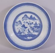 A CHINESE BLUE AND WHITE PORCELAIN DISH, the centre with a roundel containing a landscape setting,