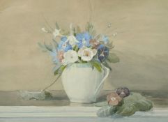 Circle of Kate Cameron (20th Century) A still life of spring flowers in a green and white jug,