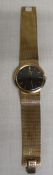 Gents 9ct gold Omega wristwatch with black dial and gold baton markers, manual wind movement, on