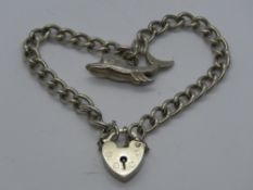 A silver charm bracelet having hallmarked heart padlock clasp,