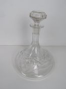 A cut glass ships style decanter, with stopper.