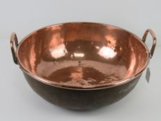 A large copper balti style pan, 40cm dia with twin handles.