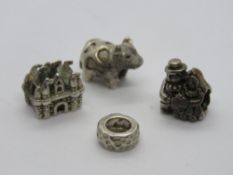Three 925 silver charms including a cow marked Cham 925, together with another bead - unmarked.