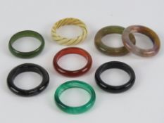 Seven hard stone rings inc carnelian and tigers eye with chalcedony matrix.