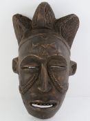 An African carved wooden wall mask, 36cm high.