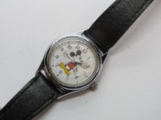 A Disney Mickey Mouse watch having white dial with black leather strap.