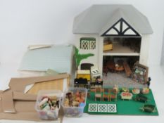 A hand built doll's house together with a large quantity of furniture and accessories inc metal