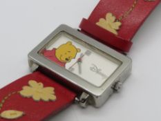 A Disney Winnie the Pooh watch on leather strap.