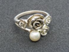 A silver Folli Follie ring having floral design with single pearl, stamped Folli Follie with 925,