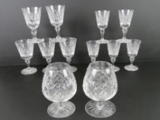 A pair of Edinburgh Crystal brandy balloons together with a matching set of five wine glasses and