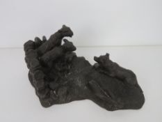 A heredites bronzed figurine of a sheep dog and lambs.