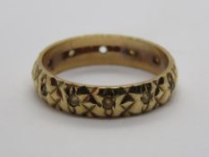 A 9ct gold eternity ring having heality carved pattern studded with white stones, size L, 2.2g.