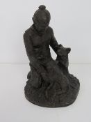 A heredites bronzed figurine of a shepherd and dog.