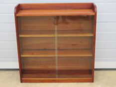 A glazed sliding door bookshelf in the style of Minty 90 x 23 x 94cm.