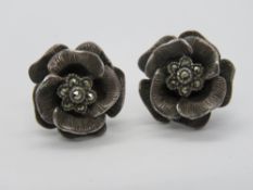 A pair of silver and marcasite floral stud earrings, each stamped 925 and measuring 17mm dia.